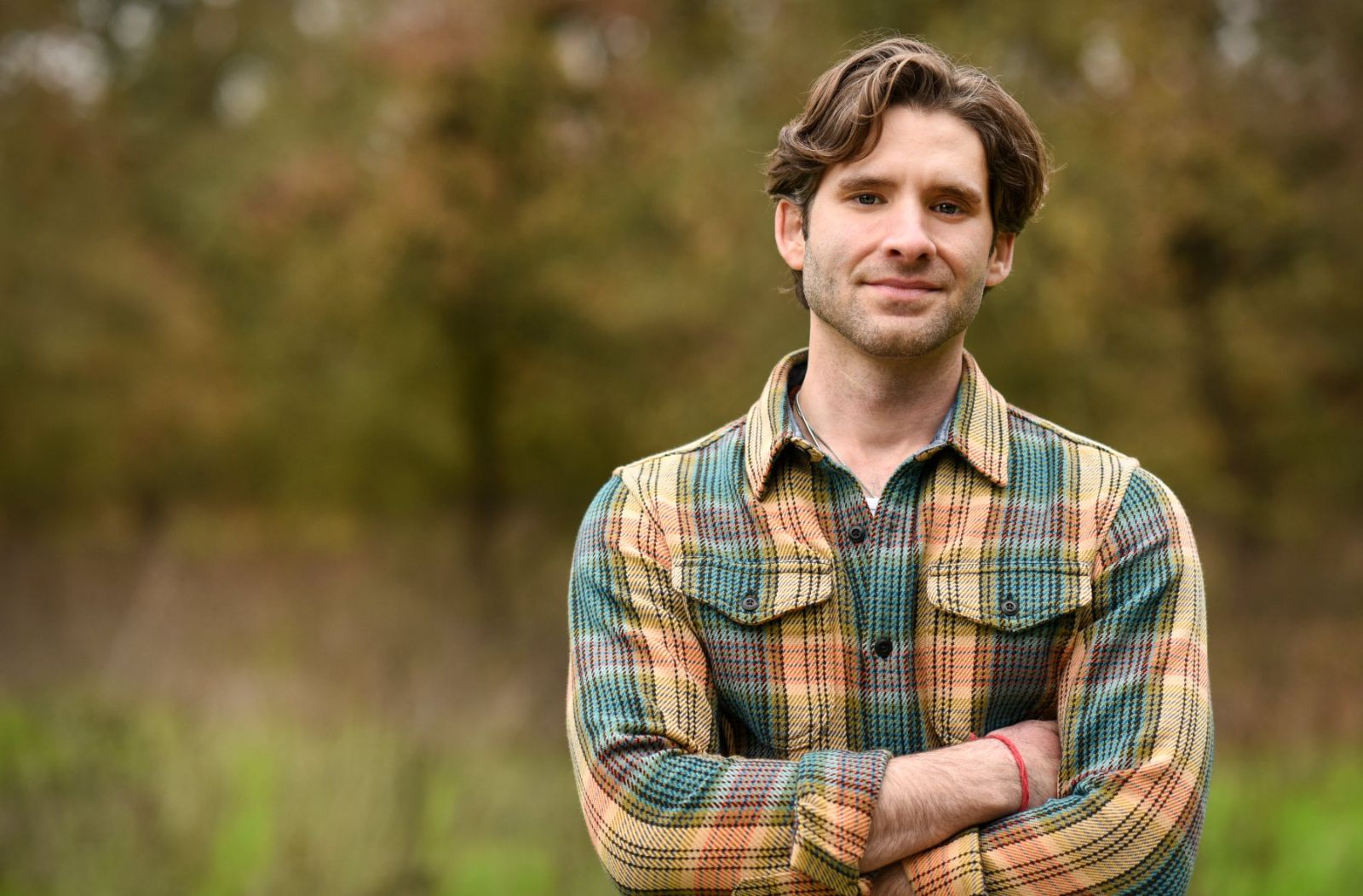 John Murray, therapist and founder of Integral Path Counseling, standing outdoors with his arms crossed